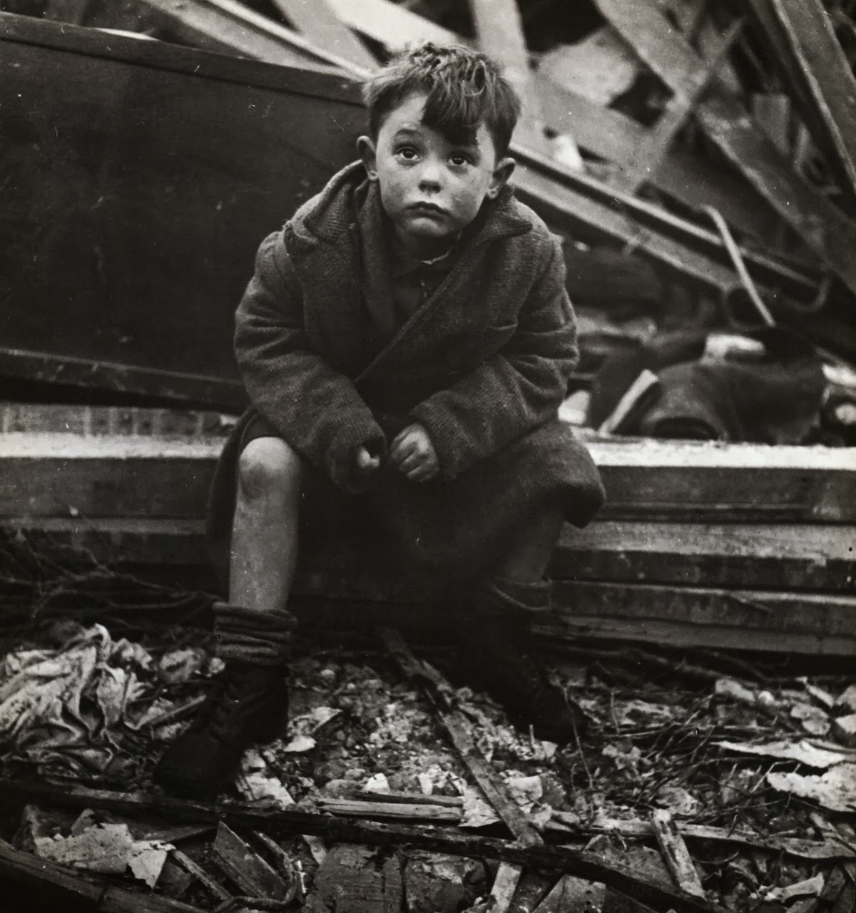 abandoned_boy_holding_a_stuffed_toy_animal_amid_ruins_following_german_aerial_bombing_of_london_1940